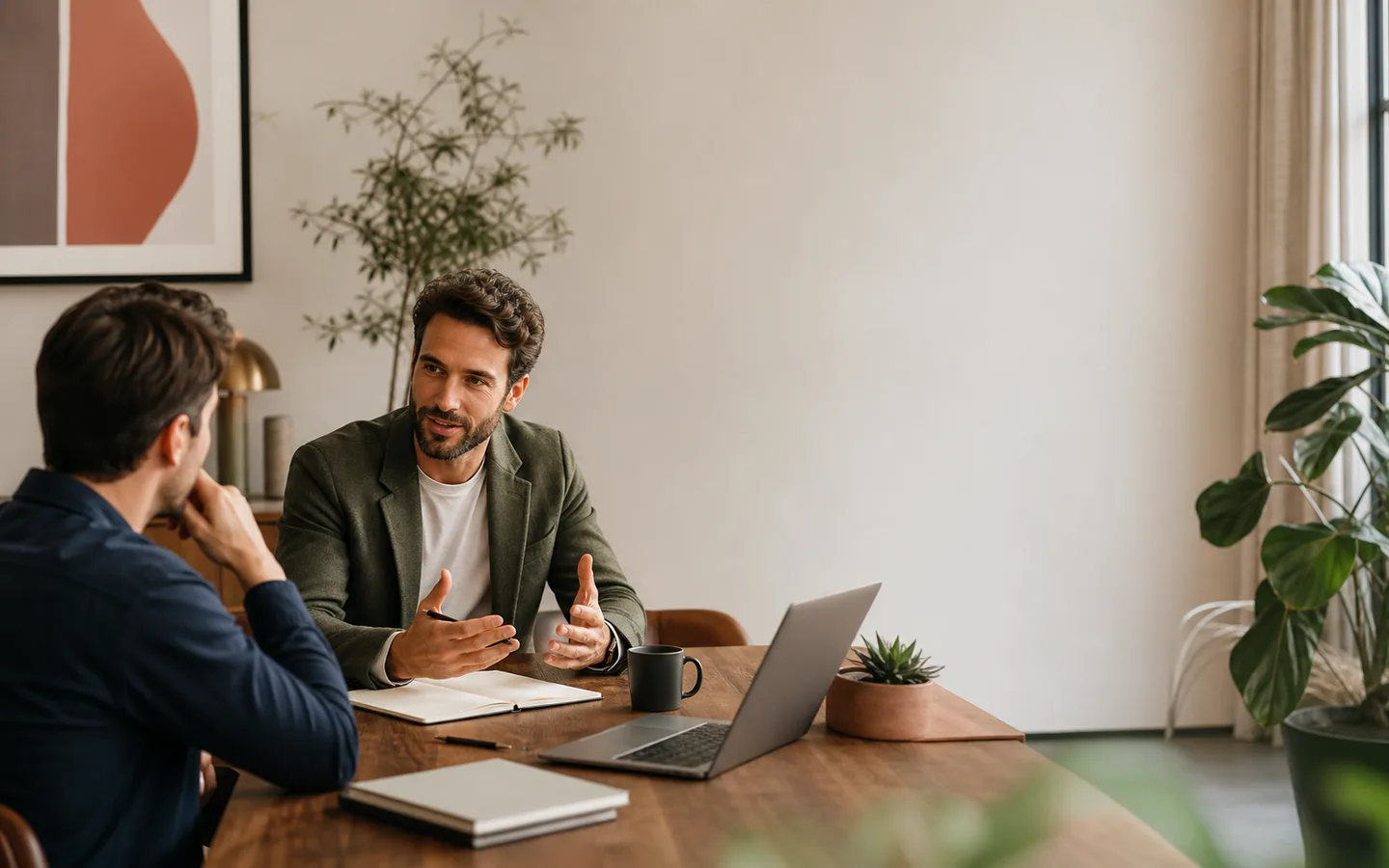 Professional consultant speaking with a founder in a warm office.