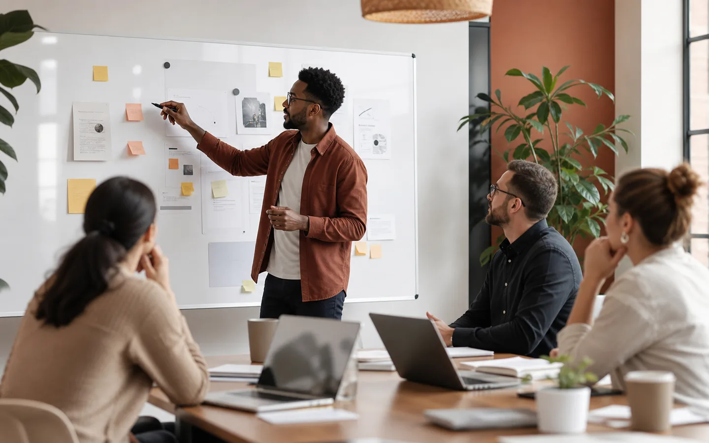Consultant leading a strategy workshop with founders.
